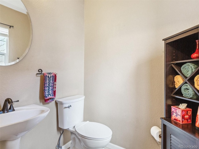 3893 Ute Mountain Trl, Castle Rock, CO 80109 - bathroom featuring baseboards, a sink, and toilet