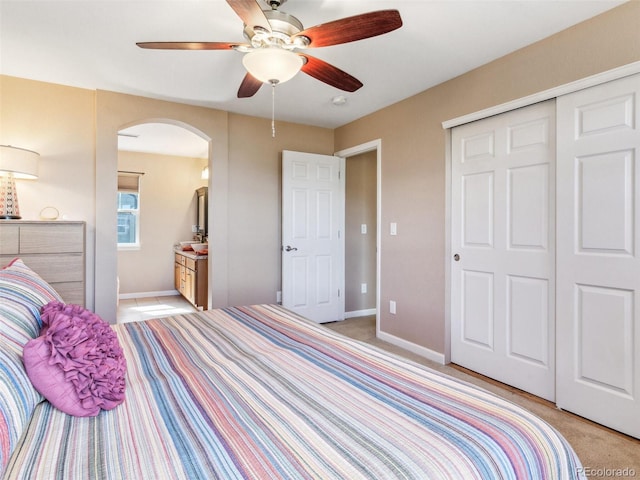 3893 Ute Mountain Trl, Castle Rock, CO 80109 - bedroom with arched walkways, baseboards, a closet, and light colored carpet