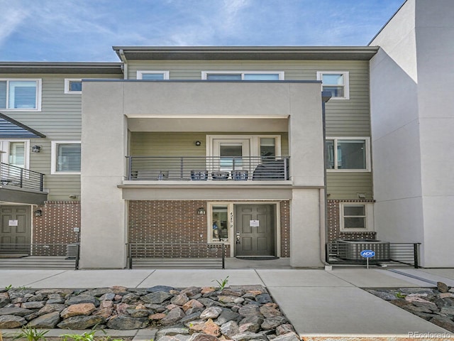 4245 E Iliff Ave Unit 2, Denver, CO 80222 - rear view of property with central AC, brick siding, a balcony, and stucco siding