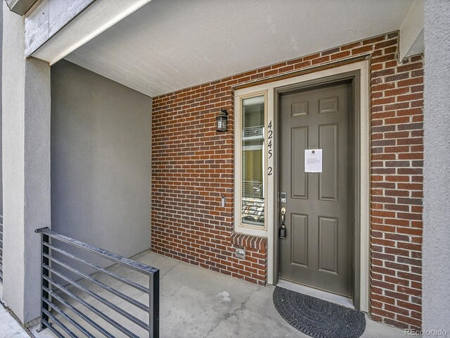 4245 E Iliff Ave Unit 2, Denver, CO 80222 - doorway to property featuring brick siding