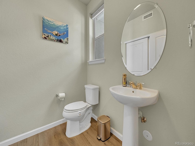 4245 E Iliff Ave Unit 2, Denver, CO 80222 - half bath with baseboards, wood finished floors, visible vents, and toilet