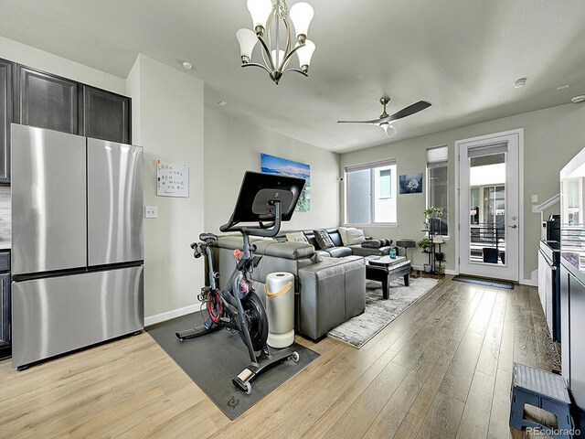 4245 E Iliff Ave Unit 2, Denver, CO 80222 - workout area featuring baseboards, ceiling fan with notable chandelier, and light wood-type flooring