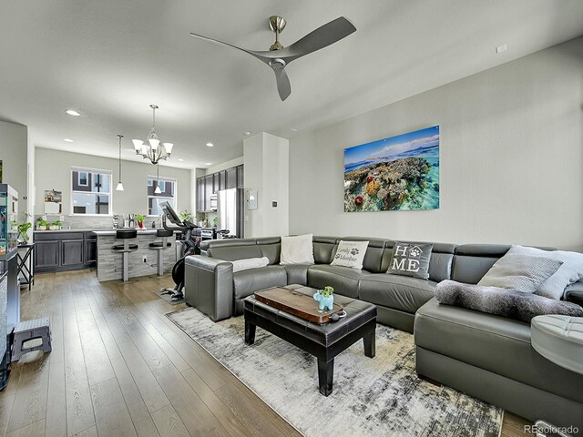 4245 E Iliff Ave Unit 2, Denver, CO 80222 - living room with recessed lighting, light wood-type flooring, and ceiling fan with notable chandelier