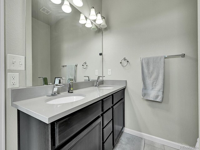 4245 E Iliff Ave Unit 2, Denver, CO 80222 - bathroom with baseboards, visible vents, a sink, and double vanity