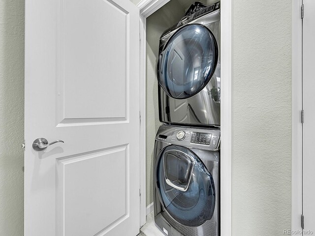 4245 E Iliff Ave Unit 2, Denver, CO 80222 - laundry area featuring a textured wall, stacked washer / dryer, and laundry area