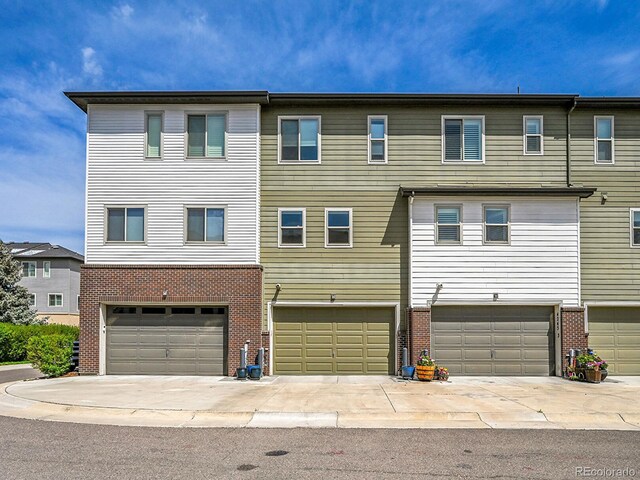 4245 E Iliff Ave Unit 2, Denver, CO 80222 - townhome / multi-family property with brick siding and a garage