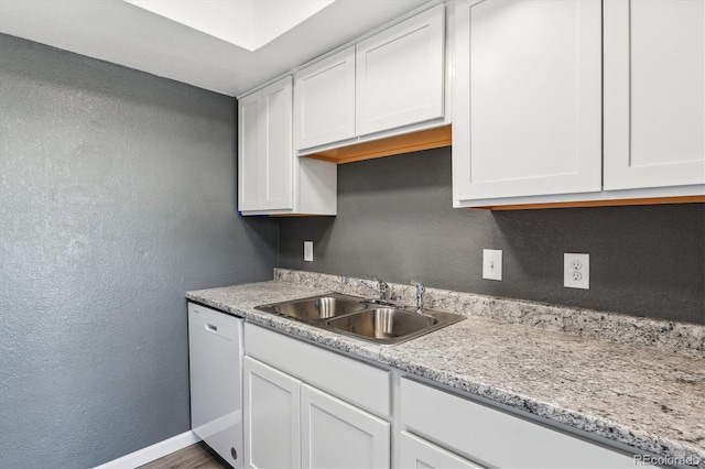 19192 E Wyoming Pl Unit 206, Aurora, CO 80017 - kitchen with a sink, light countertops, white cabinets, a textured wall, and dishwasher
