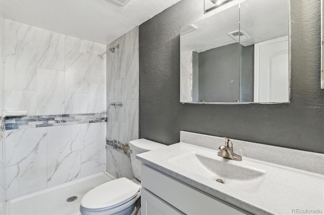 19192 E Wyoming Pl Unit 206, Aurora, CO 80017 - bathroom featuring a textured wall, vanity, a marble finish shower, and toilet