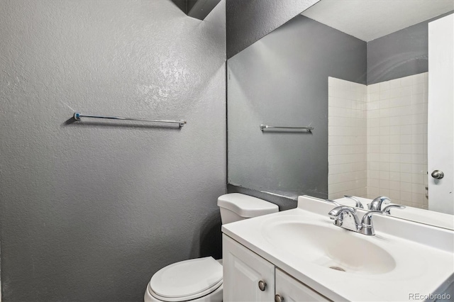 19192 E Wyoming Pl Unit 206, Aurora, CO 80017 - full bathroom featuring toilet, vanity, and a textured wall