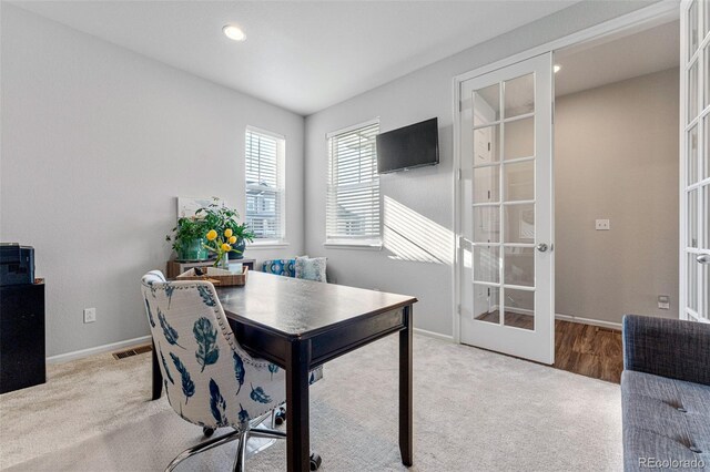 office space featuring french doors and light carpet