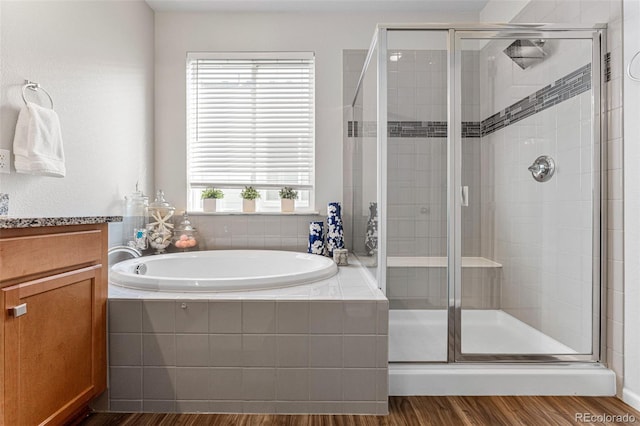 bathroom featuring vanity, shower with separate bathtub, and hardwood / wood-style flooring