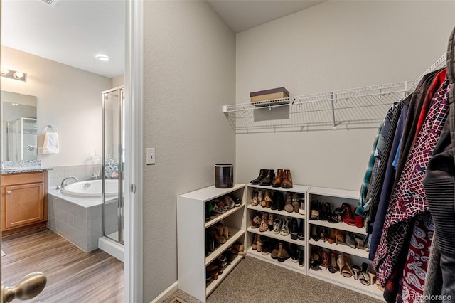 spacious closet with light hardwood / wood-style flooring