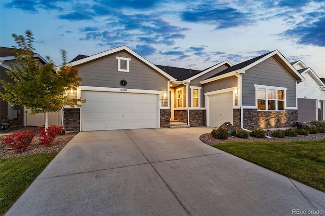 view of front of property featuring a garage and a front lawn