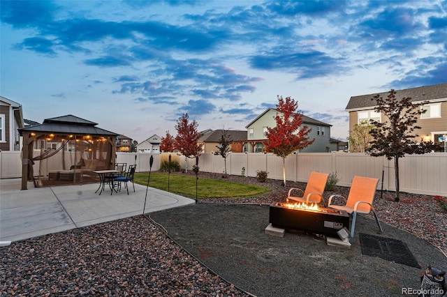 view of yard with a fire pit, a gazebo, and a patio