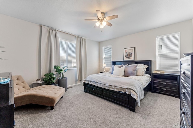 bedroom with ceiling fan and light colored carpet