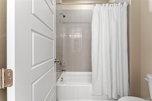 bathroom with shower / bath combination with curtain and toilet