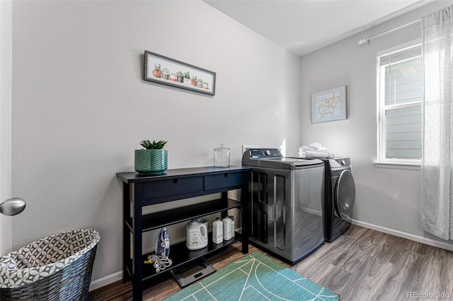 washroom with washer and clothes dryer and wood-type flooring