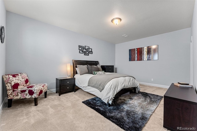 bedroom with light colored carpet