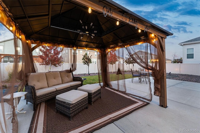 patio terrace at dusk featuring a gazebo and outdoor lounge area