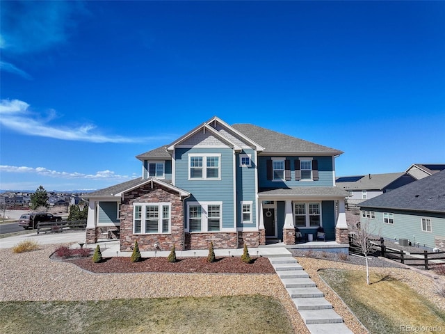 view of front of property with covered porch and stone siding