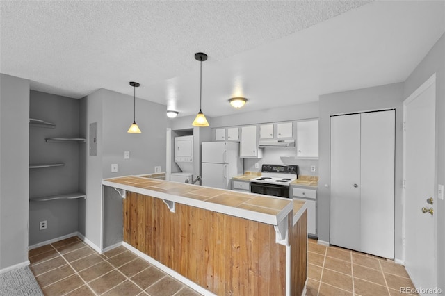 kitchen featuring a textured ceiling, white cabinetry, hanging light fixtures, and white appliances