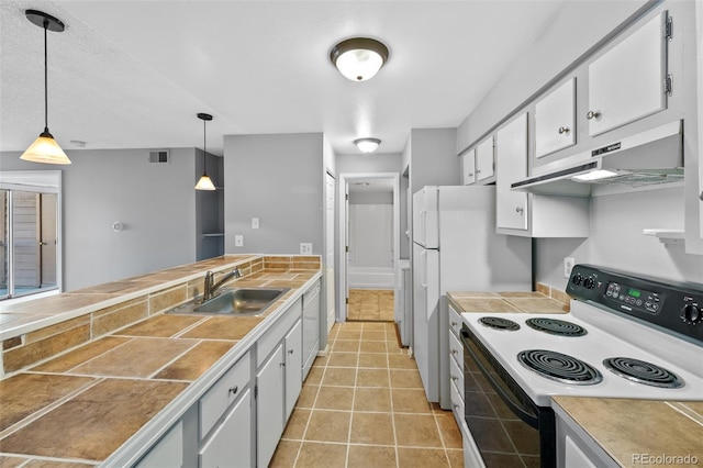 kitchen with white cabinetry, sink, hanging light fixtures, white appliances, and light tile patterned floors