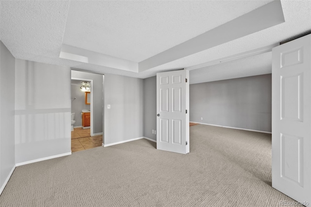 interior space featuring carpet flooring and a textured ceiling