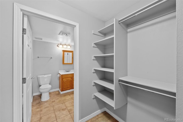 spacious closet featuring light tile patterned flooring