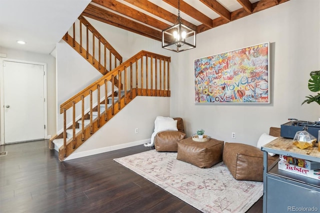 living area featuring beamed ceiling, dark wood-type flooring, and a notable chandelier