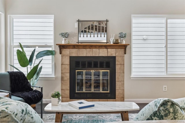 living room featuring hardwood / wood-style flooring and a tiled fireplace