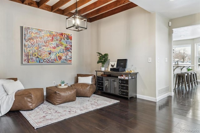 living area featuring beam ceiling, dark hardwood / wood-style floors, and a notable chandelier