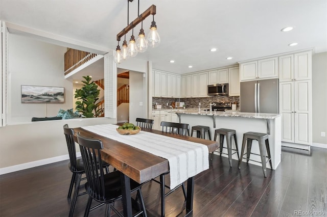 dining room with dark hardwood / wood-style flooring