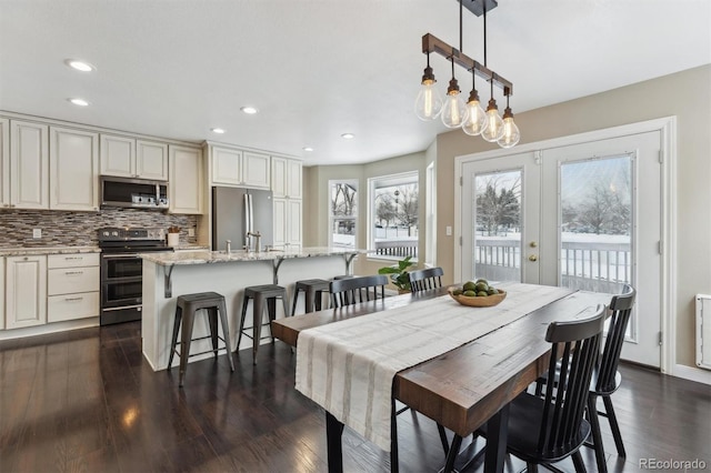 dining space with french doors and dark wood-type flooring