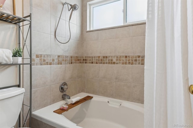 bathroom featuring shower / bath combo and toilet