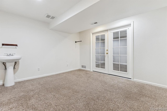 unfurnished room with carpet floors and french doors