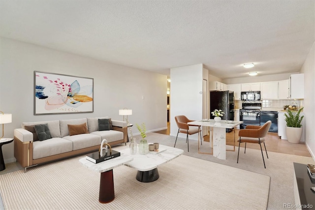 living room with baseboards and a textured ceiling