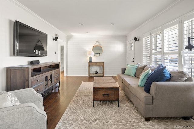 living room with crown molding and wood finished floors