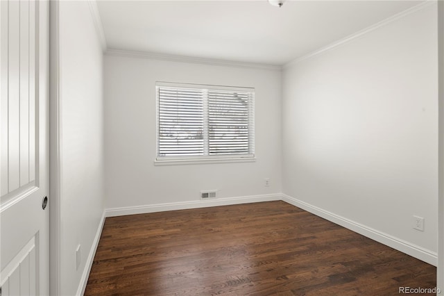 empty room with dark wood-style floors, baseboards, visible vents, and crown molding