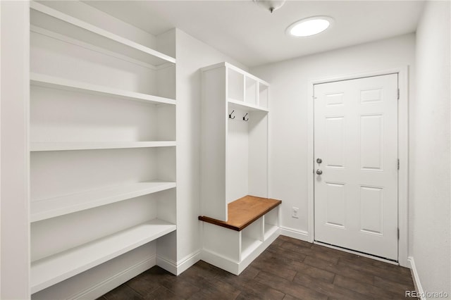 mudroom featuring dark wood finished floors and baseboards