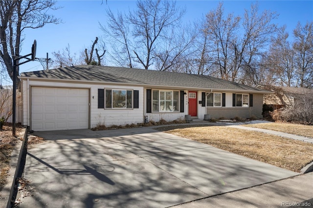 single story home featuring an attached garage, driveway, and brick siding