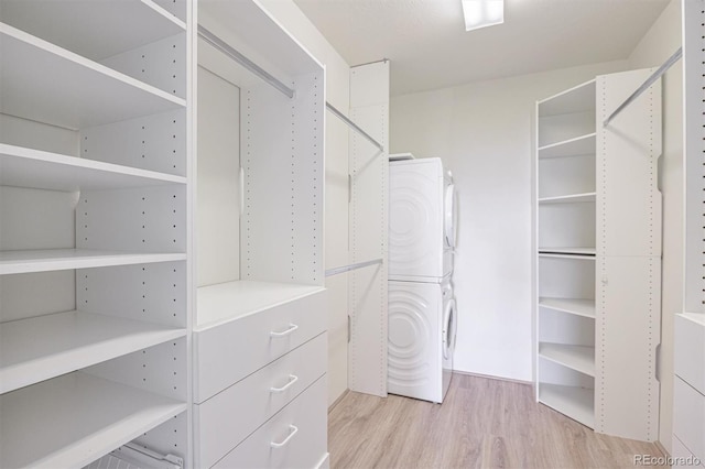 460 S Marion Pkwy Unit 1103, Denver, CO 80209 - walk in closet with stacked washer / dryer and light wood-type flooring