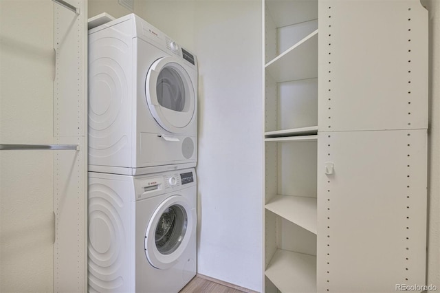 460 S Marion Pkwy Unit 1103, Denver, CO 80209 - laundry room with stacked washer / drying machine and wood finished floors