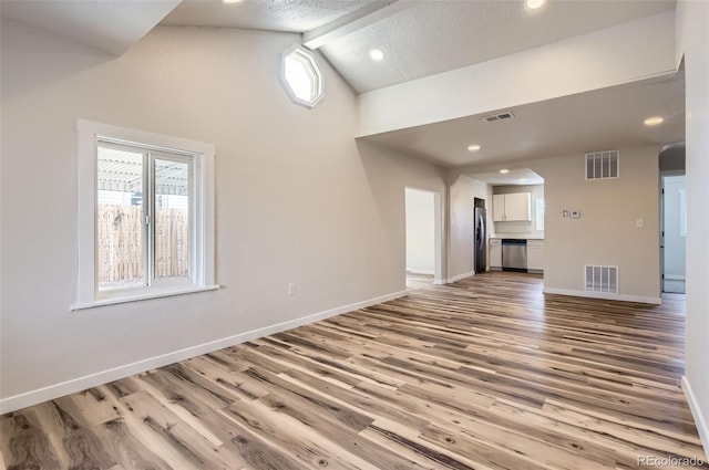 unfurnished living room with high vaulted ceiling, light hardwood / wood-style floors, and beamed ceiling