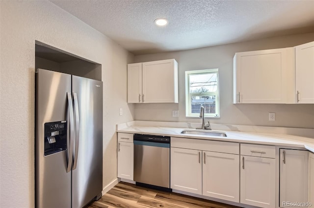 kitchen with white cabinetry, sink, and appliances with stainless steel finishes