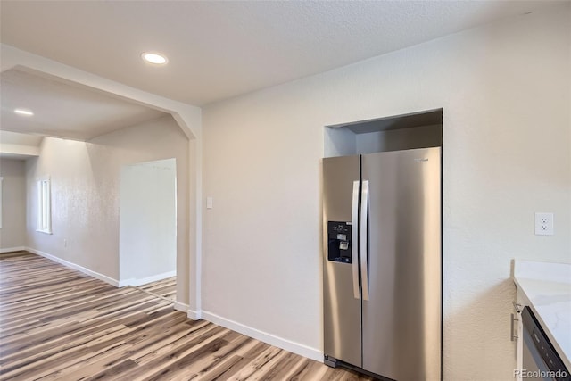 kitchen featuring stainless steel appliances and light hardwood / wood-style floors