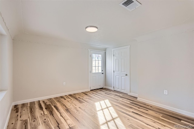 spare room featuring wood-type flooring