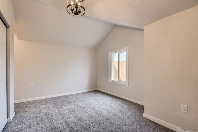 bonus room with lofted ceiling, a chandelier, and dark carpet