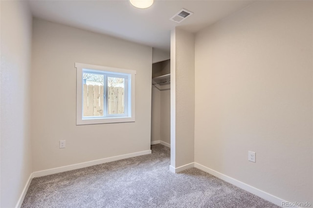 unfurnished bedroom with carpet flooring and a closet