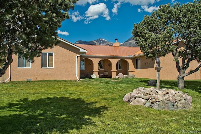 1564 Wagon Wheel Rd, Crestone, CO 81131 - rear view of property with a yard, stucco siding, a porch, and a metal roof