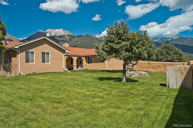 1564 Wagon Wheel Rd, Crestone, CO 81131 - rear view of house with a mountain view, a chimney, and stucco siding